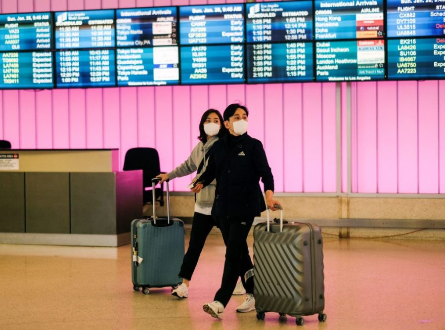 Passengers arrive at LAX from Shanghai, China, after a positive case of the coronavirus was announced in Orange County.